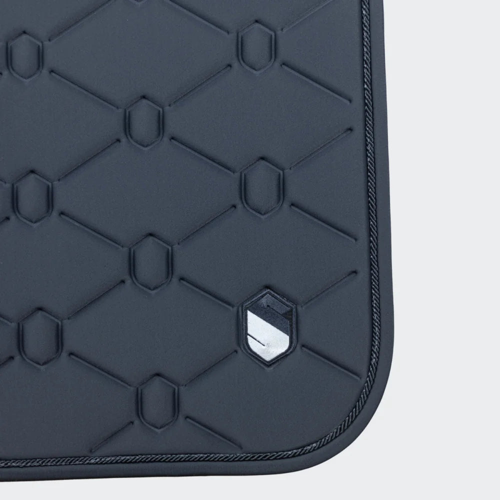 Grey quilted saddle pad on a light gray background