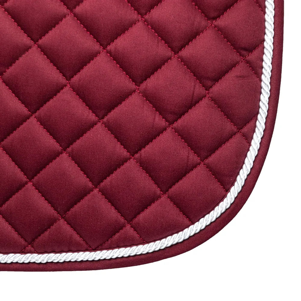 Close-up of a red quilted saddle pad with white trim on a white background