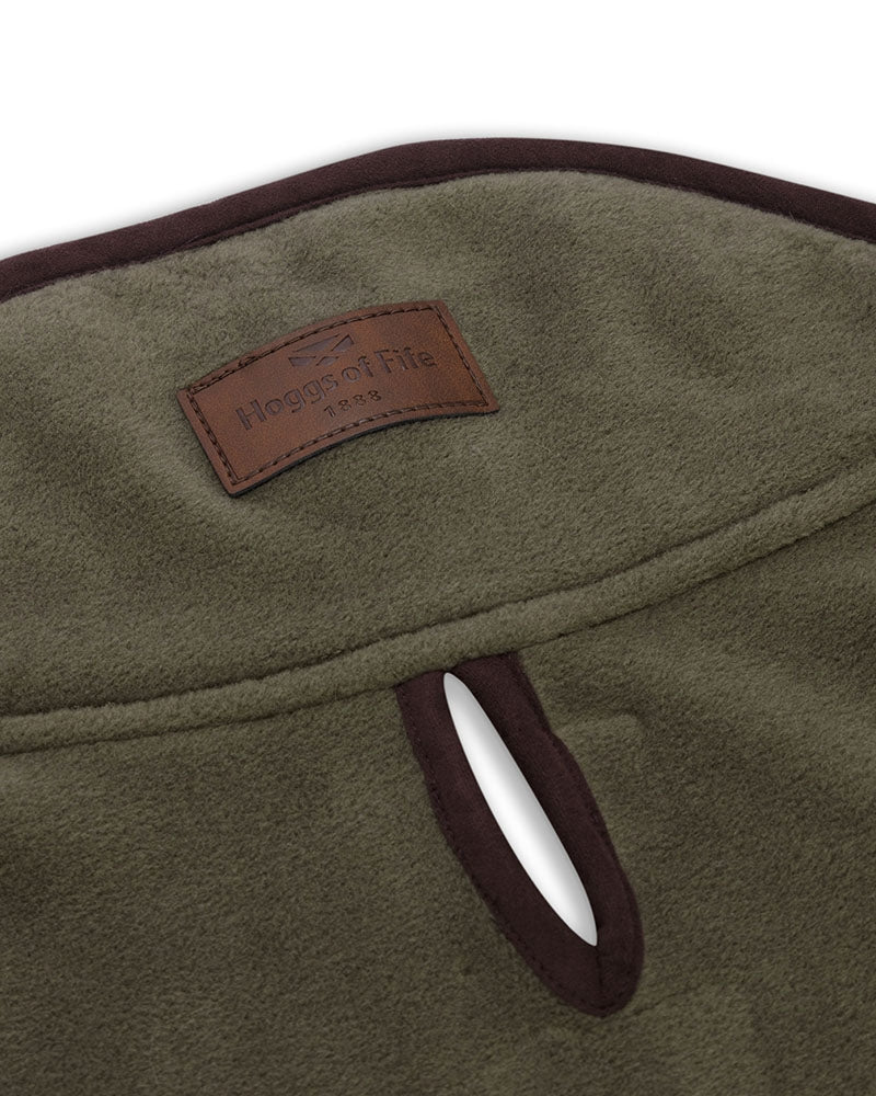 Green dog coat with brown trim on a white background