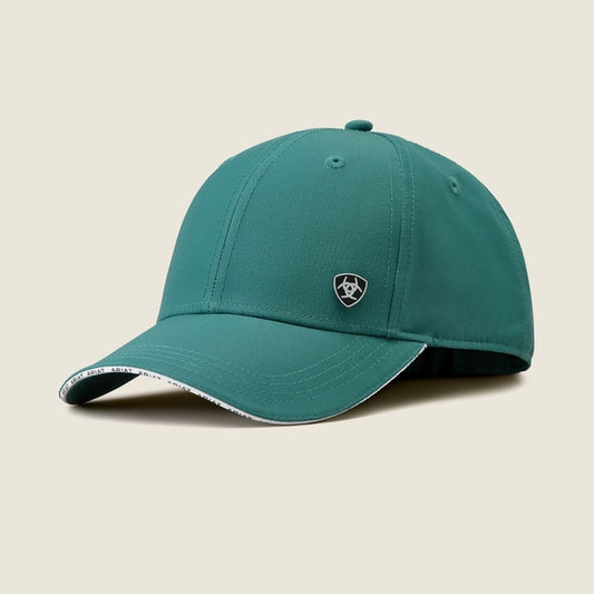 Teal baseball cap with a logo on a beige background