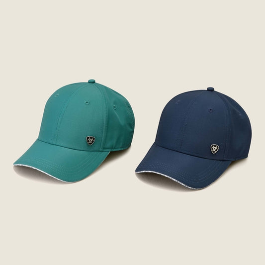 Two baseball caps, one green and one blue, on a beige background.