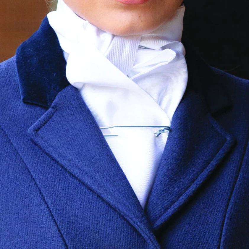 Close-up of a person wearing a blue coat and white shirt with a stock.