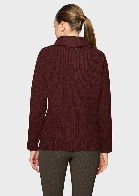 A woman shown from the back wearing a dark burgundy cable-knit sweater with a mock neck collar, paired with olive green leggings, against a plain white background.