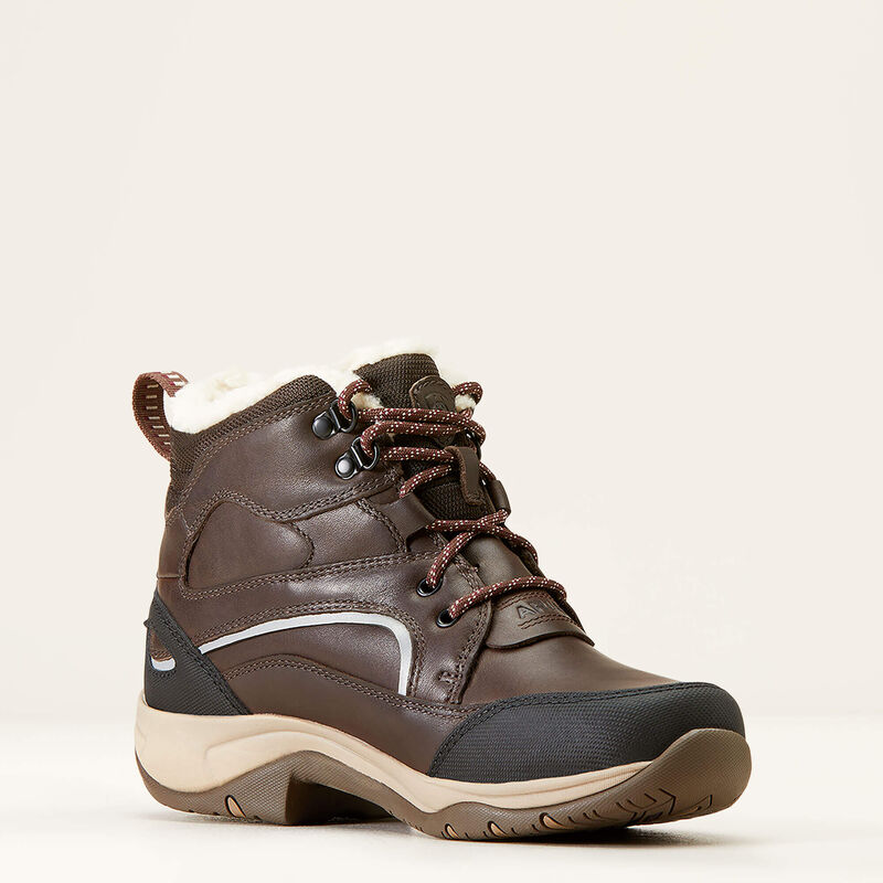 Brown hiking boot with black accents on a beige background