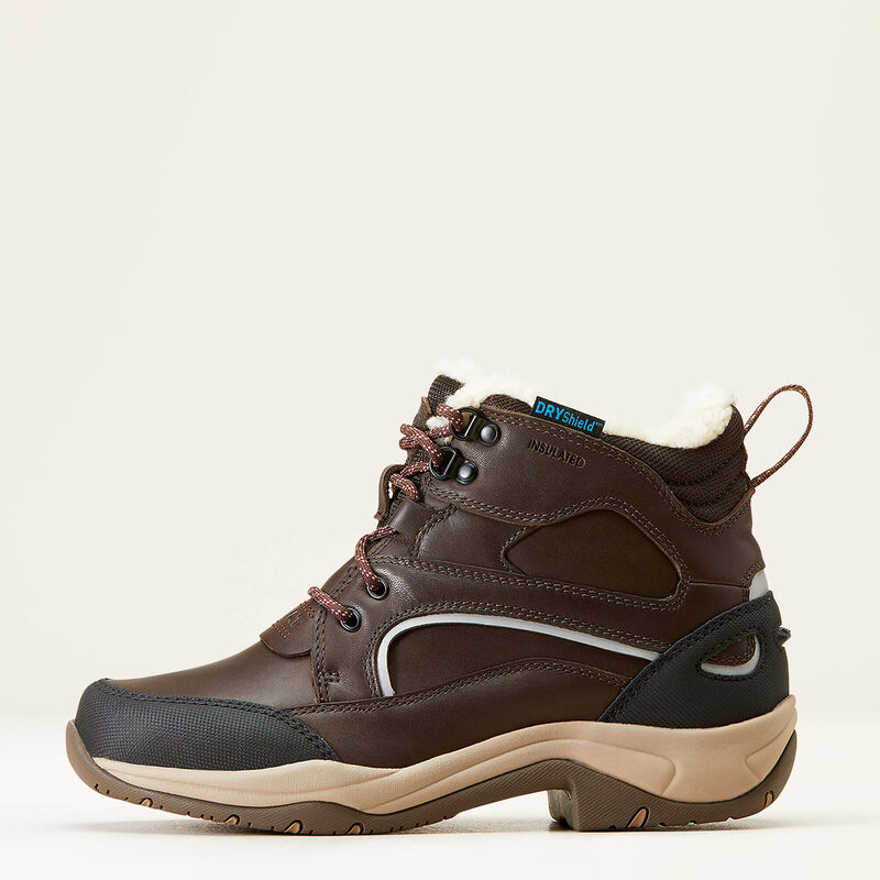 Brown hiking boot with visible brand logo on a beige background