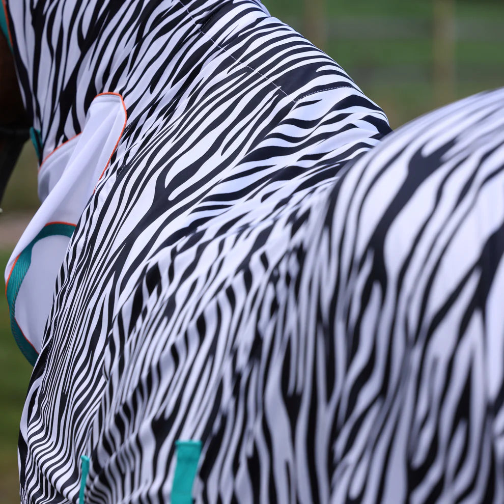 Close-up of a horse in a zebra rug with a blurred background