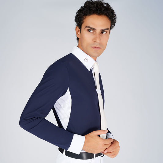 Man wearing a navy shirt with a white shirt and tie on a light gray background