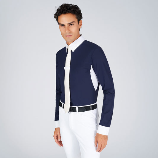 Man wearing a navy and white shirt with white pants on a light gray background