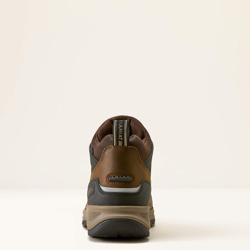 A rear view of a brown and dark gray Ariat mid-top hiking boot on a clean, off-white studio background.