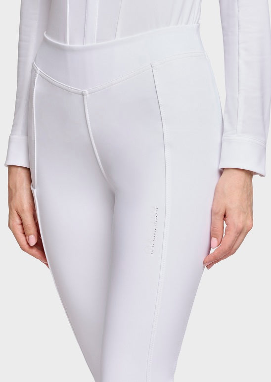 White high-waisted riding tights worn by a model, shown from the waist down with hands visible on either side against a light gray studio background.