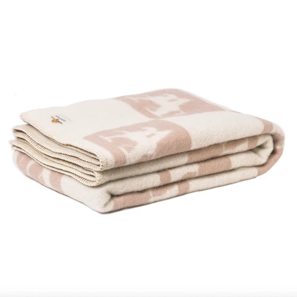 Folded beige throw on a white background