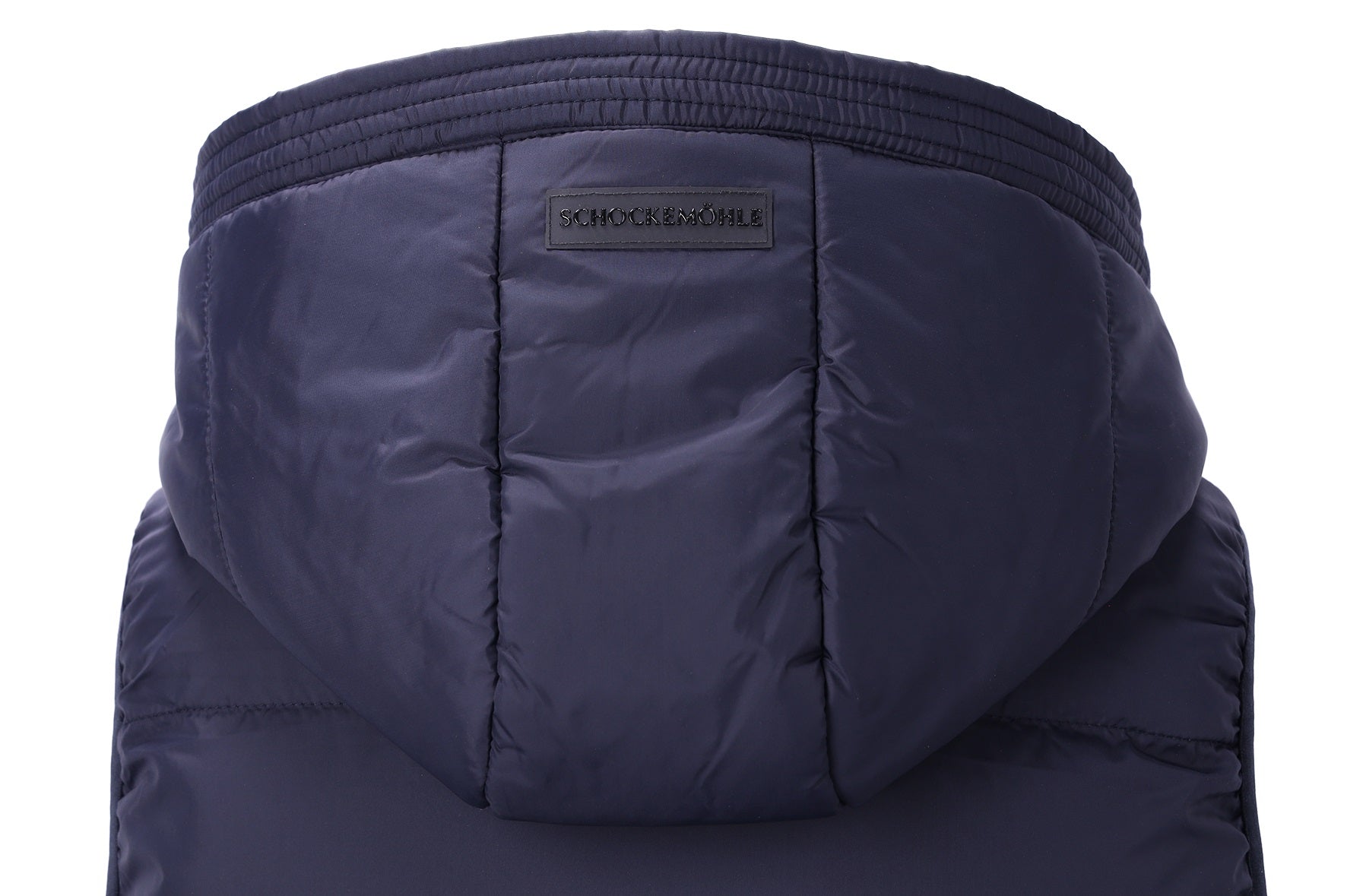 Close-up of the hood of a dark navy puffer jacket, showing quilted stitching and a small black brand label that reads 'SCHOCKEMOHLE'.