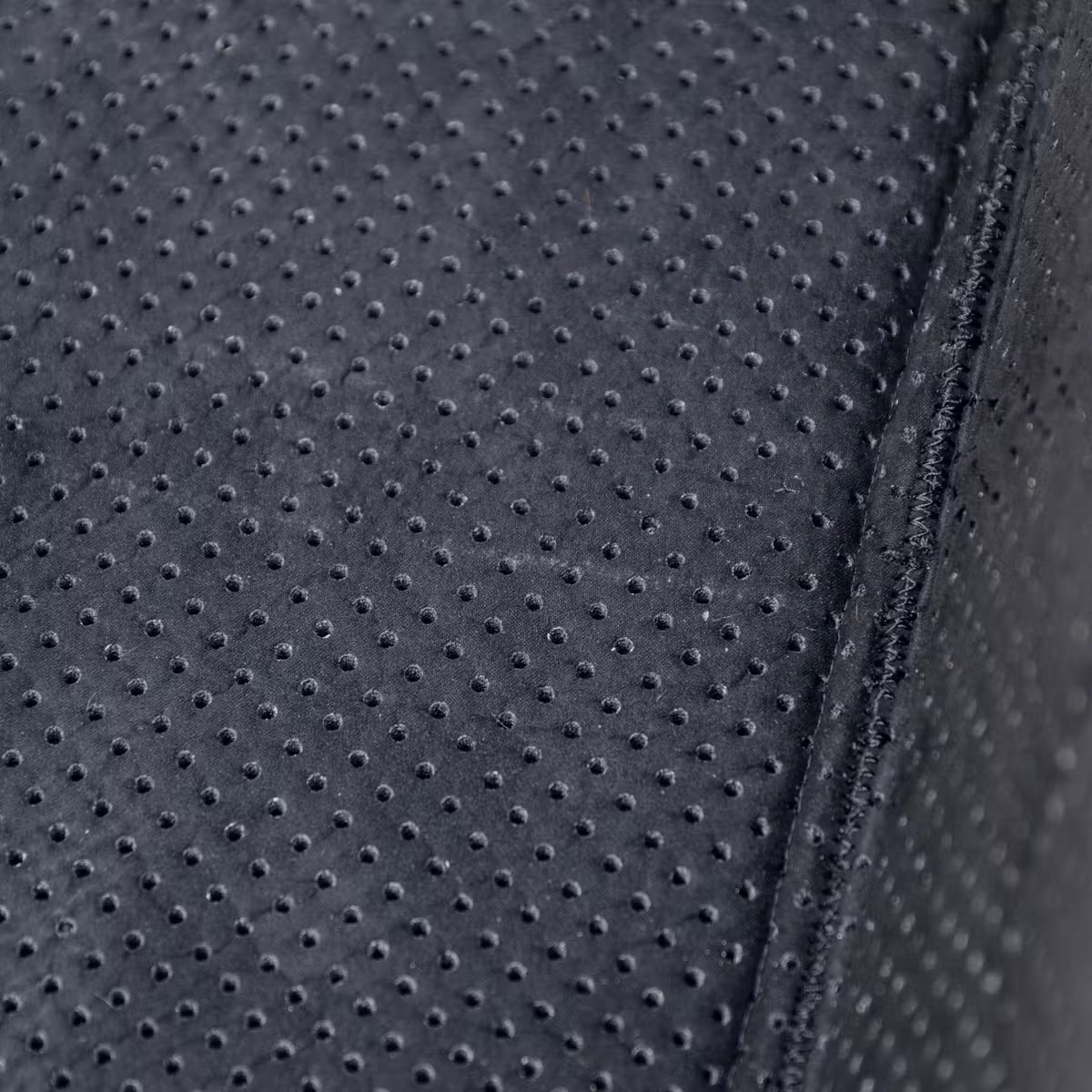 Close-up of a textured black fabric surface