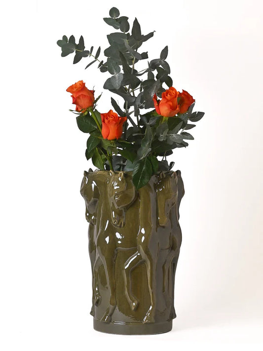 Green horse themed vase with roses in it on a white background