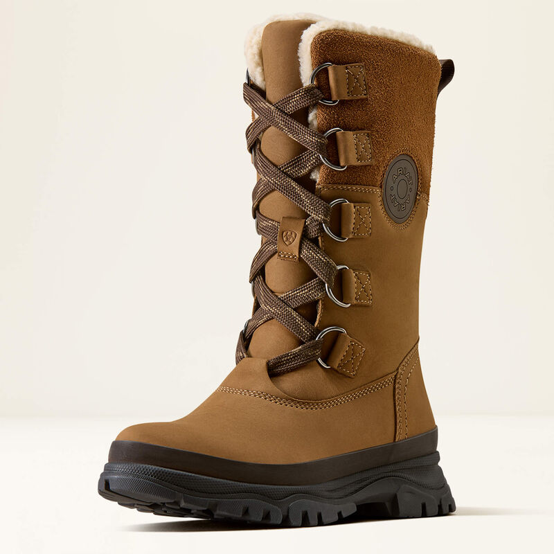 A mid-calf brown winter boot with a thick black lug sole, brown laces, and a soft white fleece lining at the collar, shown against a plain light background.