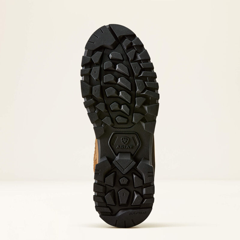 The rugged black outsole of a boot, showing deep lugs and a textured tread pattern, with the ARIAT brand logo embossed near the heel, set against a clean off-white background.