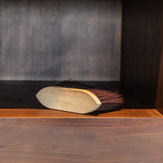 Wooden brush with bristles on a wooden surface