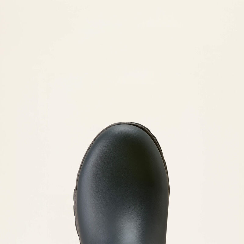Close-up of the rounded toe of a black leather boot against a solid off-white background.