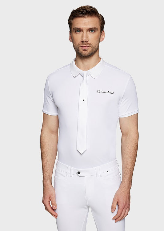 Man wearing a white polo shirt with a logo on a plain background