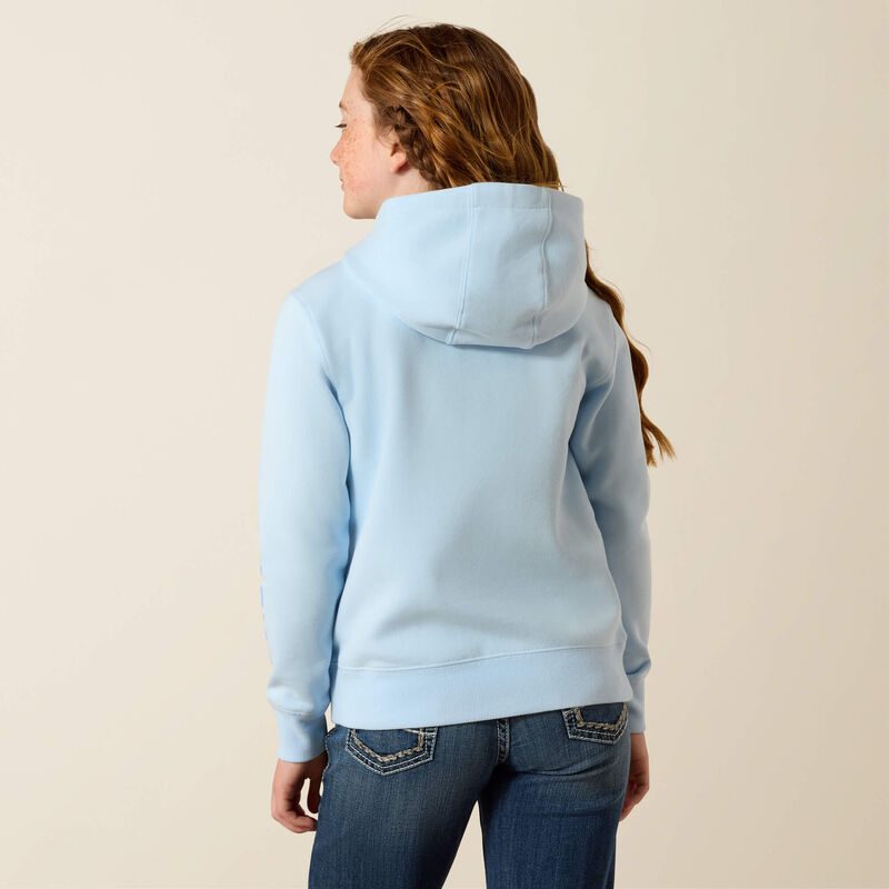 Person wearing a light blue hoodie and jeans on a beige background