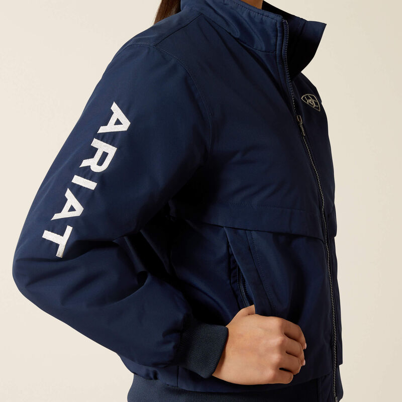 Navy blue jacket with 'Ariat' branding on a beige background