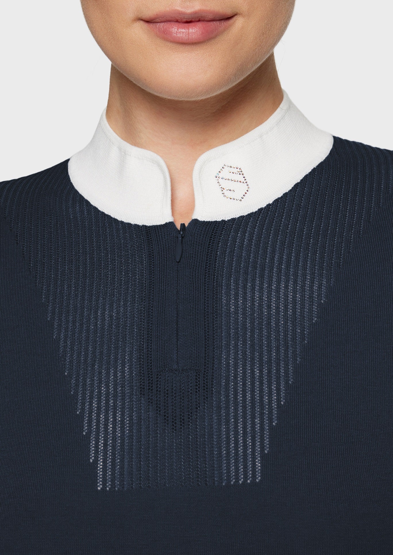 Woman wearing a navy jumper on a white background